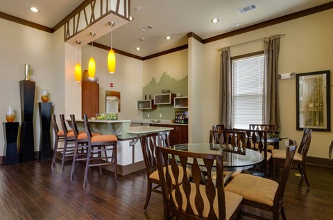 Decoroated clubroom with high cielings and large screen television at Ashley Auburn Pointe in Atlanta, GA